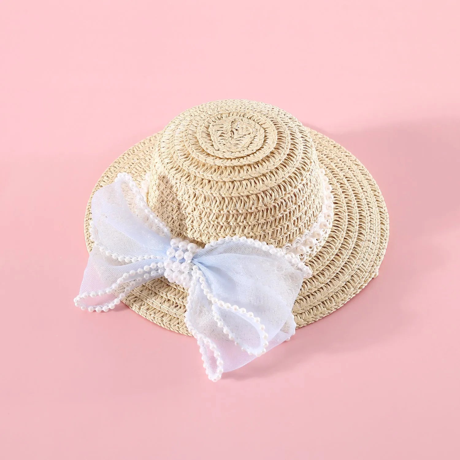 Woven straw hat for a cat with a large central pearl bow, available in blue, pink, purple, and white.
