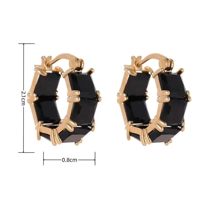 Geometric U-shaped gold-tone earrings with black zircon stones, approximately 20mm diameter
