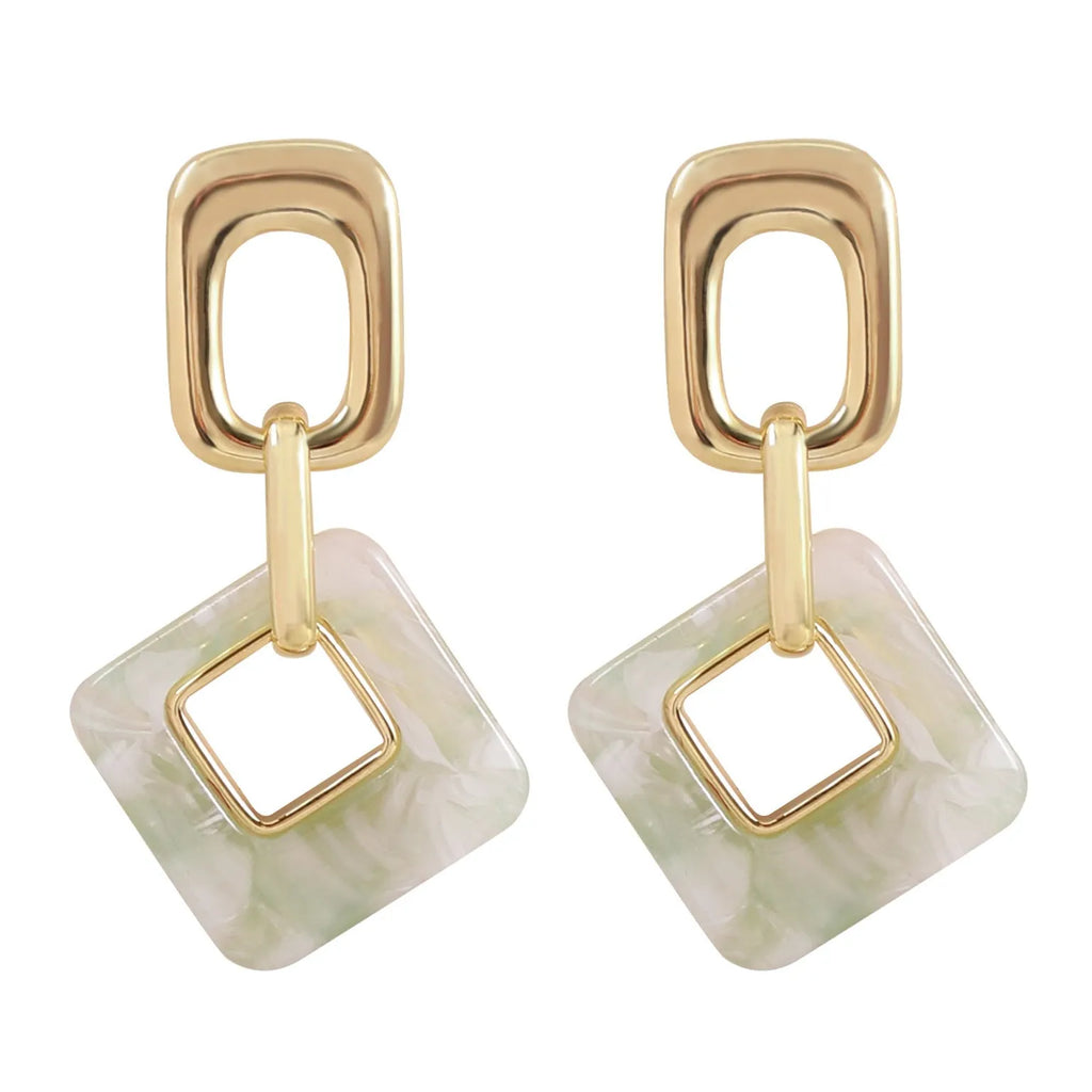 A pair of hollow geometric square earrings with chamfered corners in an electroplated copper finish.