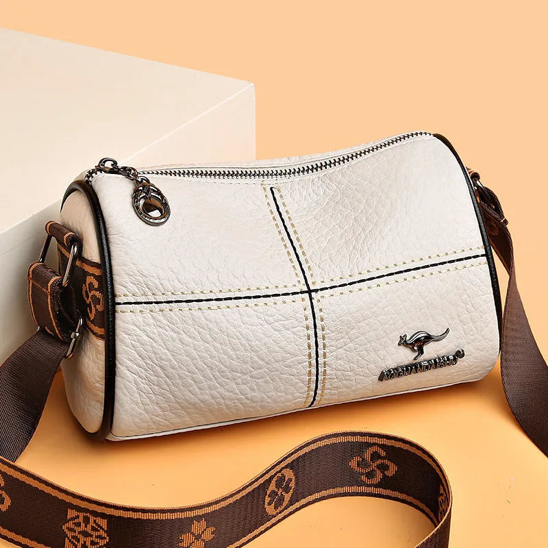 Women's casual stitched genuine leather shoulder bag in cylindrical shape, available in black, brown, green, and white