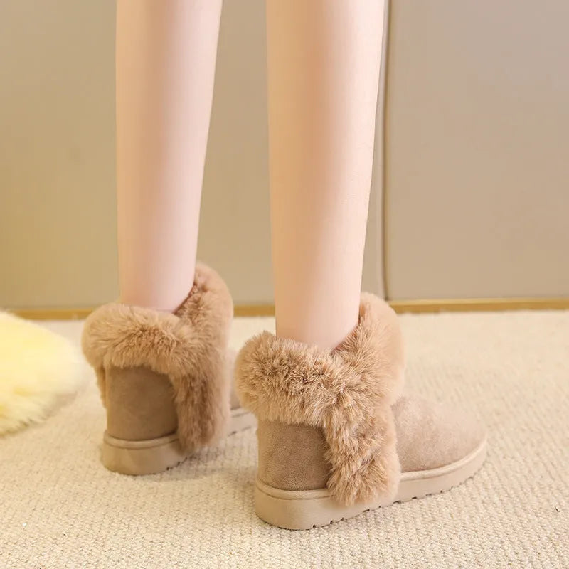 Women's winter snow boots in beige with fluffy platform, round toe, and artificial wool lining on a white background