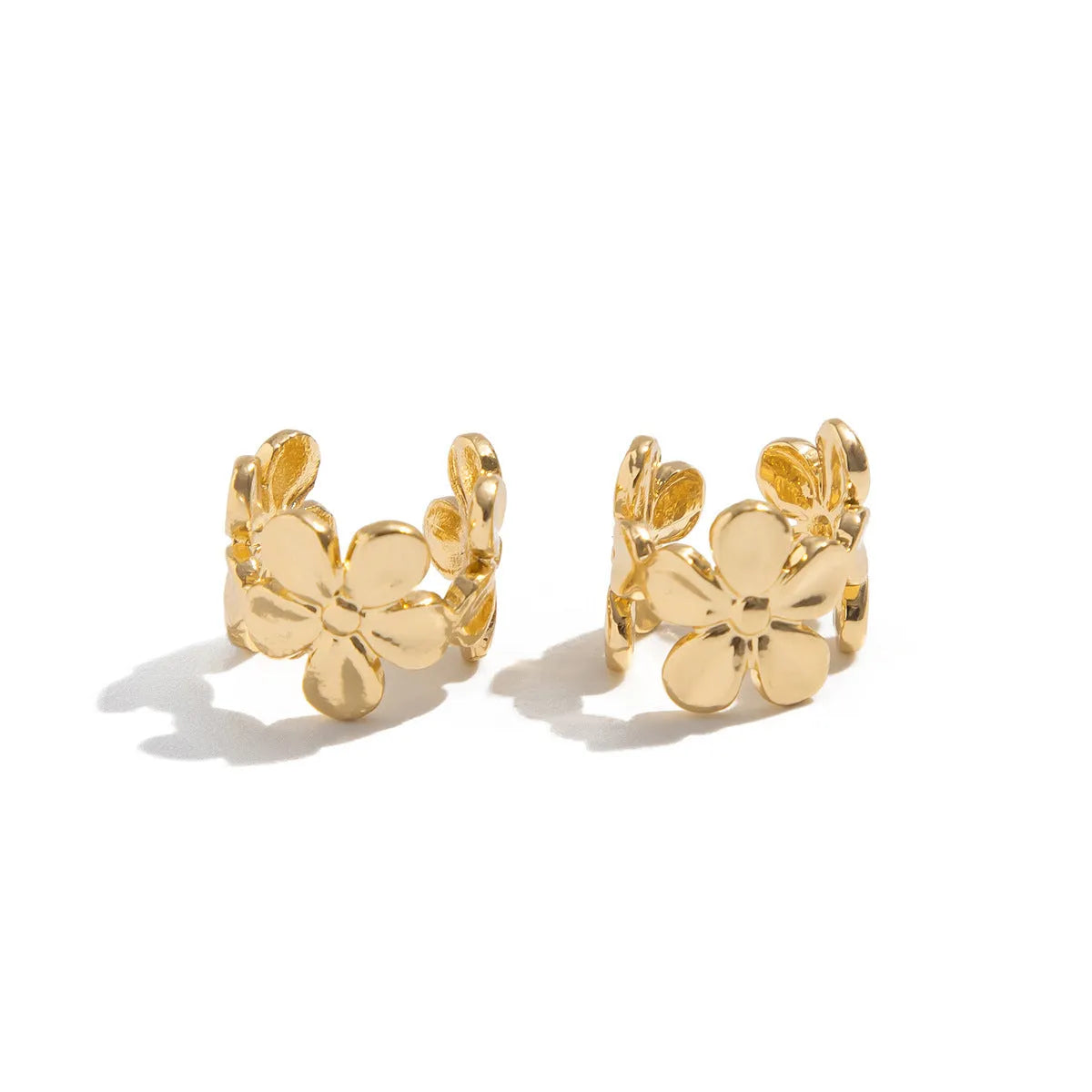 Gold-coloured starfish and scallop shell dangle earrings for women on a white background.