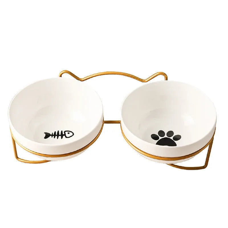 White ceramic cat bowl with cat paw print design on a black iron frame stand