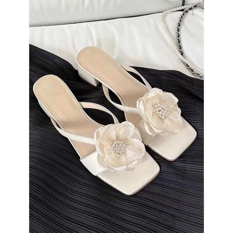 Women's cream-white satin sandals with a chunky block heel, square toe, and a single strap across the foot.