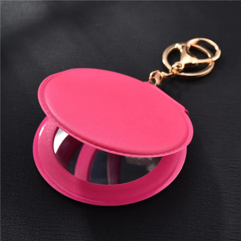 Compact round ladies leather makeup mirror with 8cm diameter glass surface and golden buckle