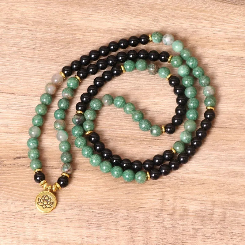 Green and black elastic beaded fashion bracelet with alloy clasp showing adjustable design