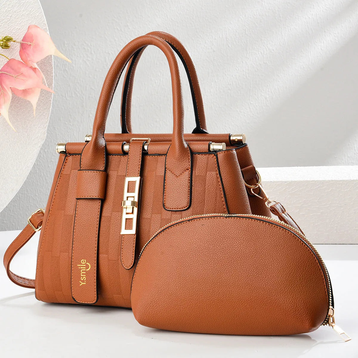 Round black PU handbag with crossbody strap shown alongside light khaki and purplish red colour options