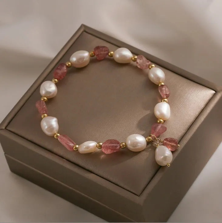 Handmade women's bracelet with strawberry quartz beads and Hetian jade peach blossom details.