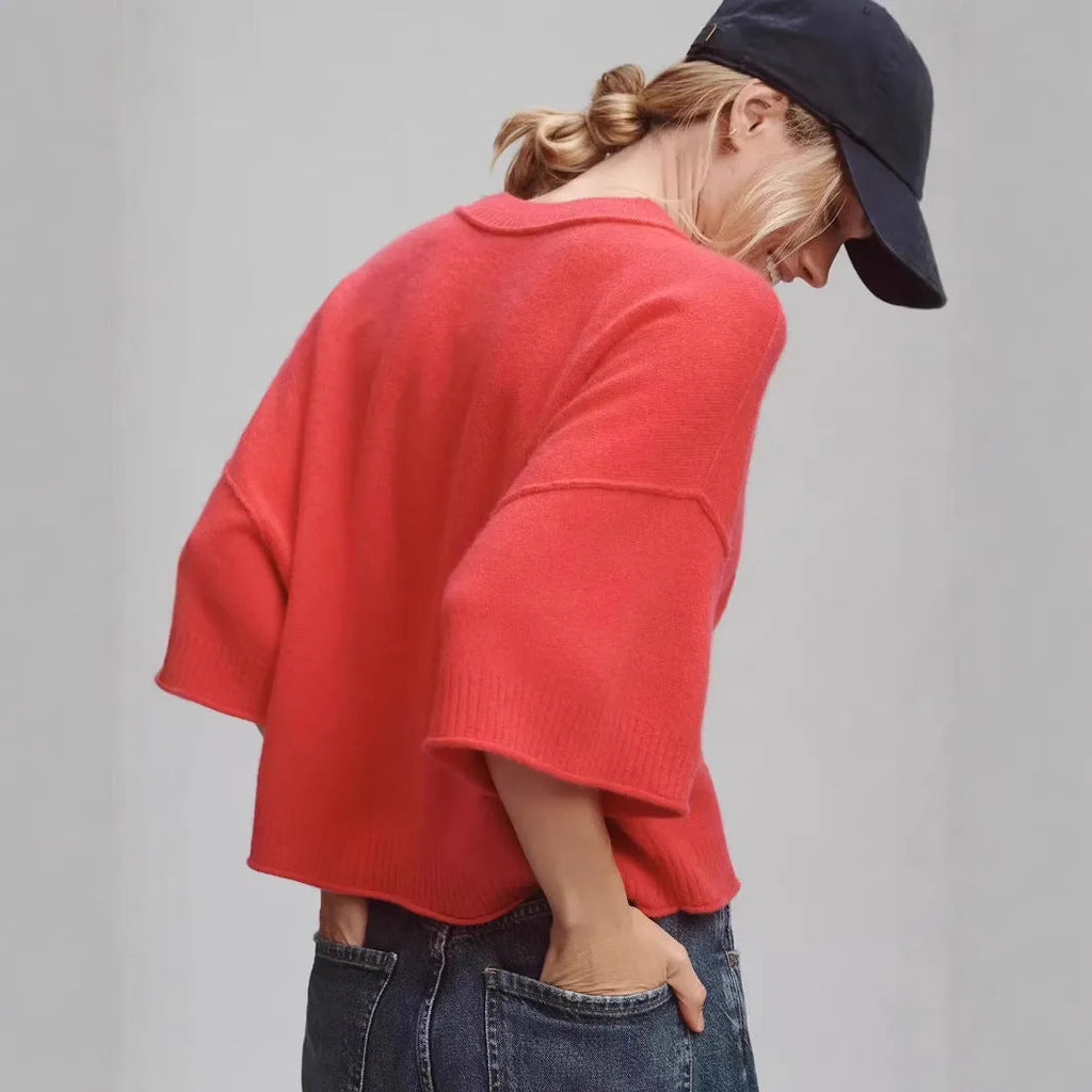 Red short sleeve viscose crop top with an exposed navel design on a model.