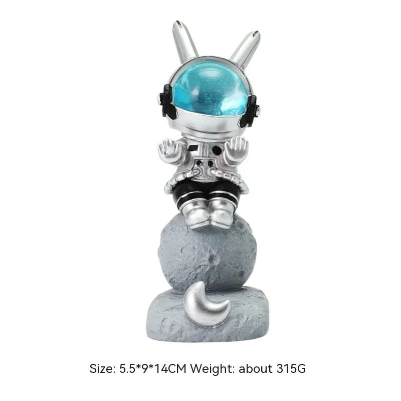 Space rabbit resin mobile phone stand in pink for desktop use