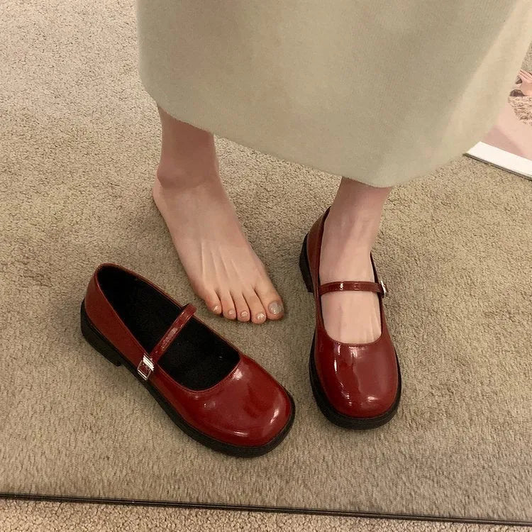 Women's flat-heeled leather shoes with round toe in red, black, and grey colour options showing vintage French styling