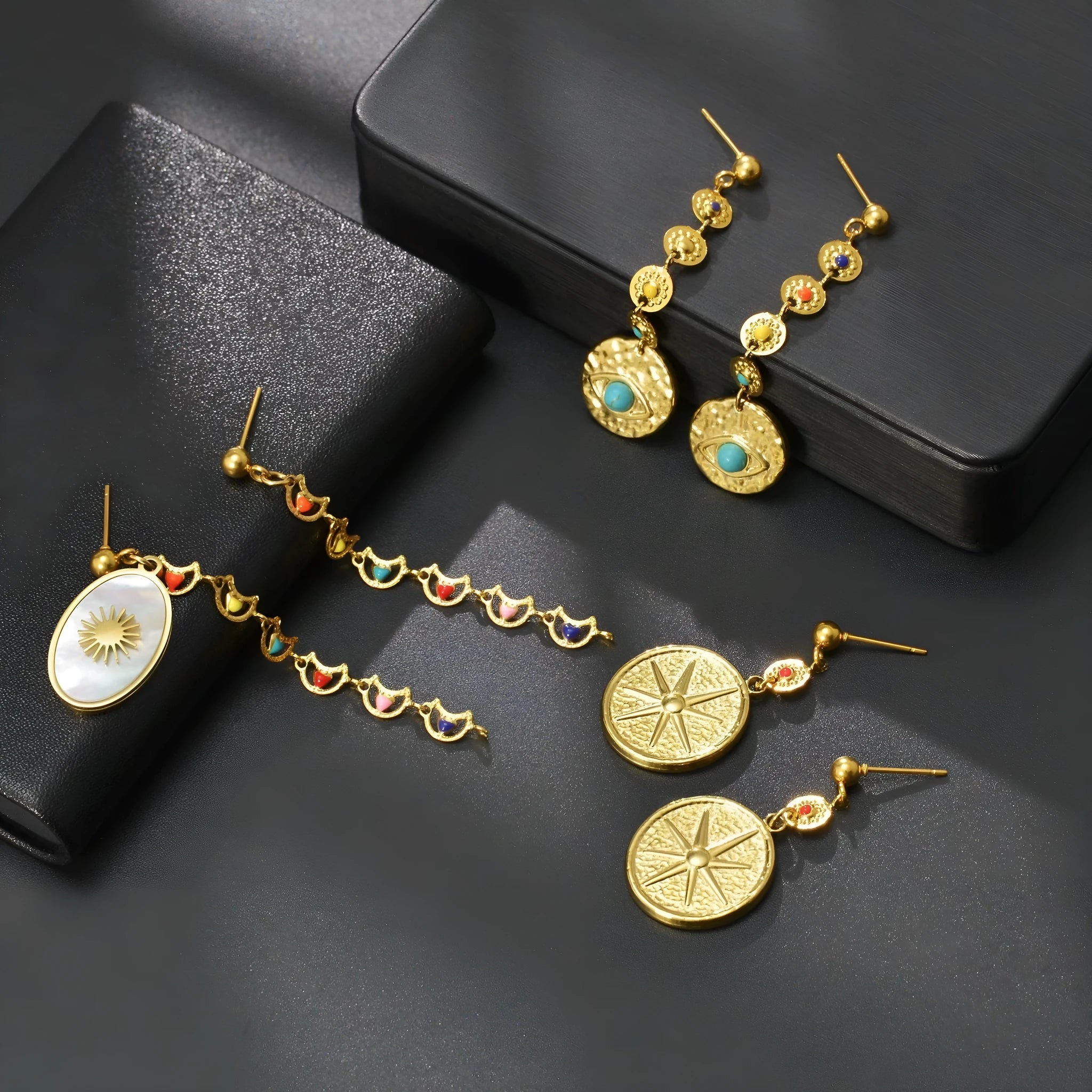 Geometric stainless steel earrings in Eight Awn Star, Eye, and Shell Sun designs
