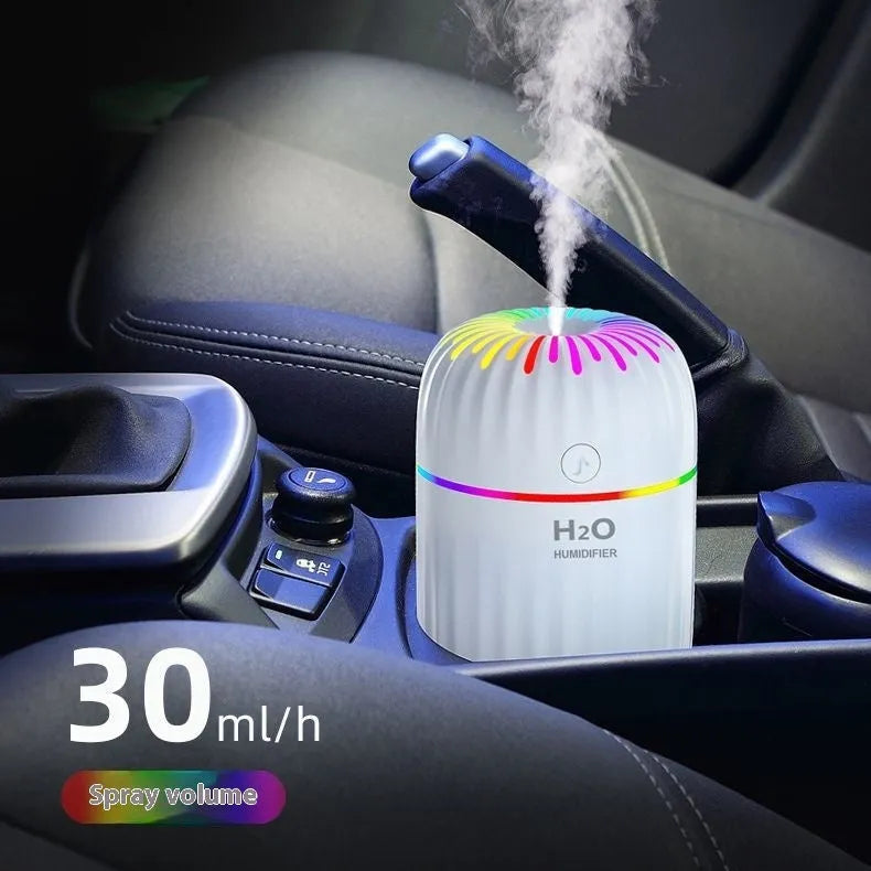 Mini animal-shaped USB aromatherapy humidifier in green, pink, or white colour on a desk.
