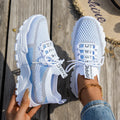 Women's lace-up Flyknit mesh sneakers in a grey colour combination with a round toe and flat rubber sole.