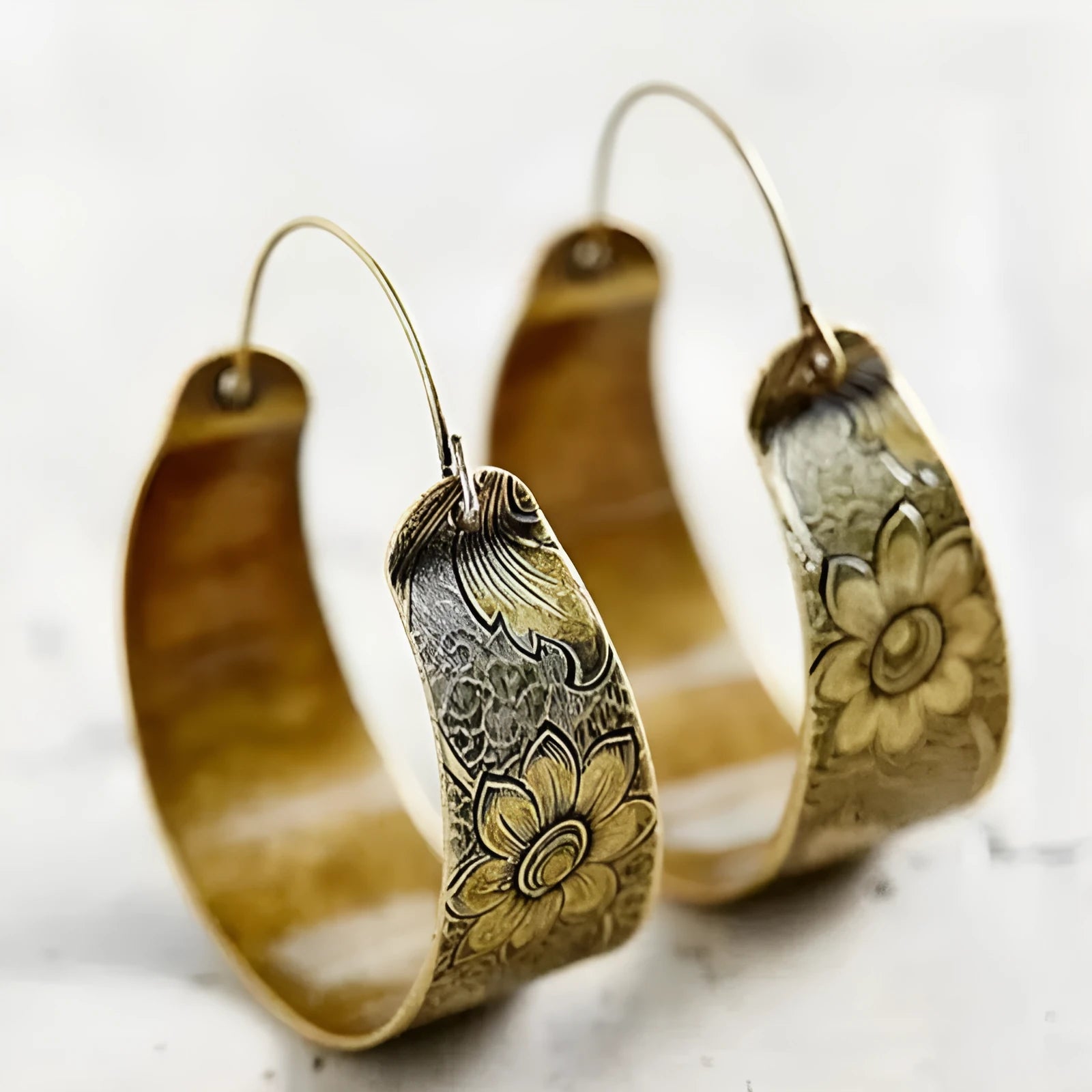 Gold hollow pattern Maillard style alloy geometric petal earrings for women on a white background