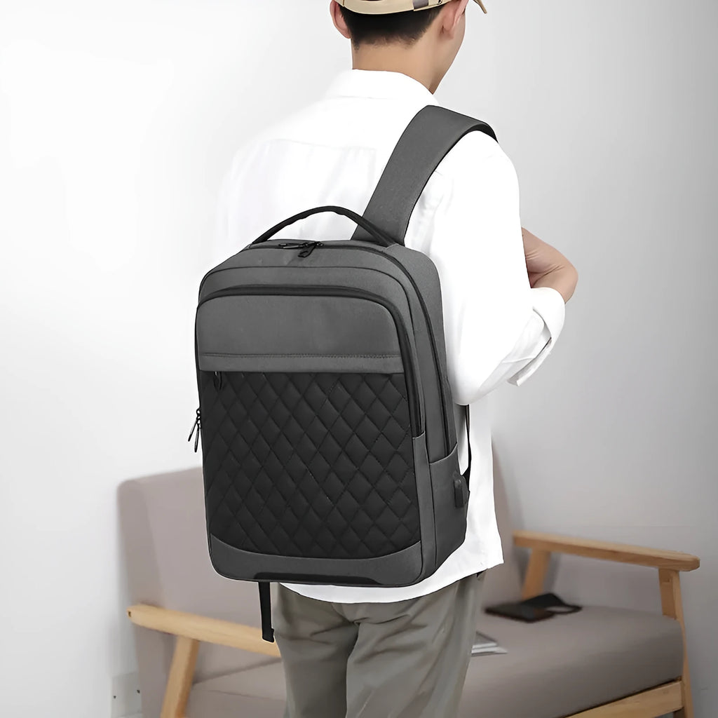 Men's Oxford cloth leisure travel backpack in black with curved shoulder strap and diamond mesh detail