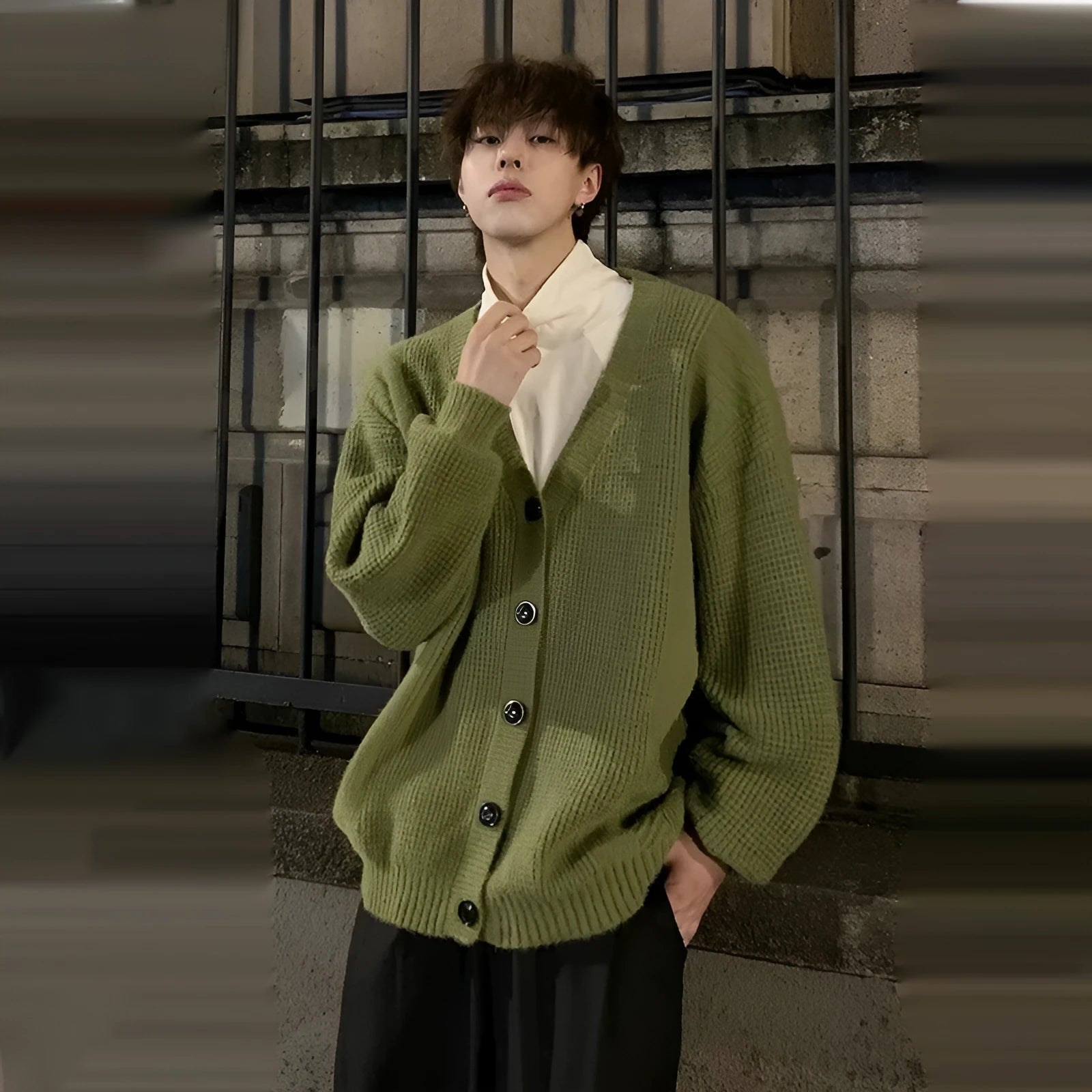 Men's loose-fit V-neck knit cardigan in army green, shown on a hanger.