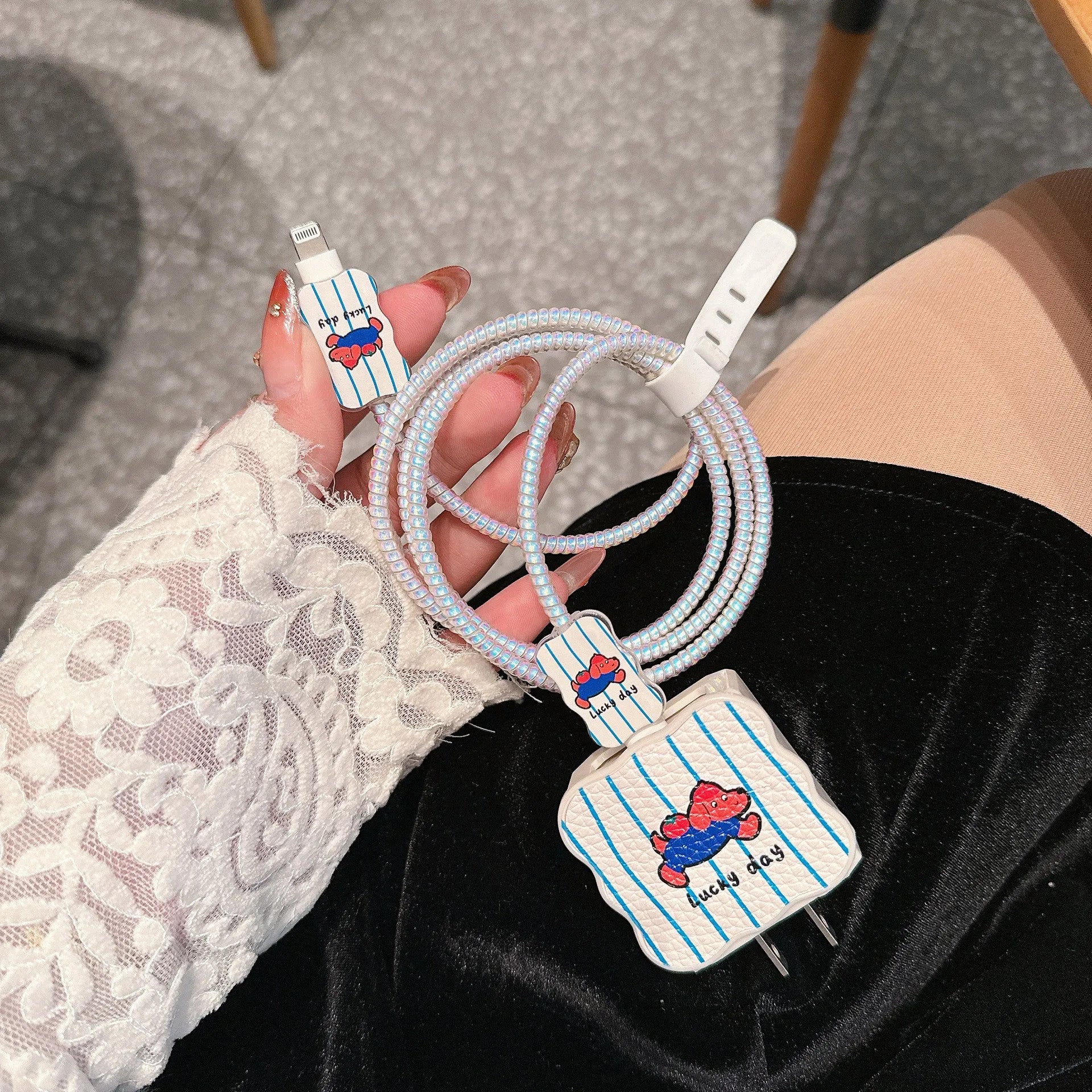 Set of four cartoon-design lambskin USB cable protection sleeves for 18W and 20W fast chargers.