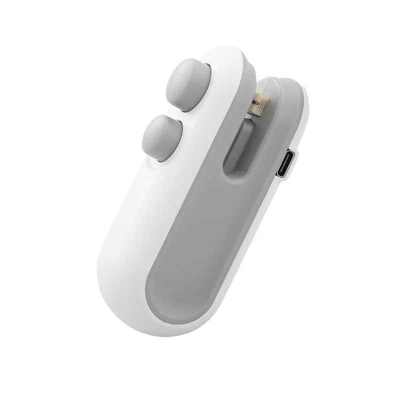 White and blue handheld USB rechargeable heat sealer for sealing food bags with magnetic back.