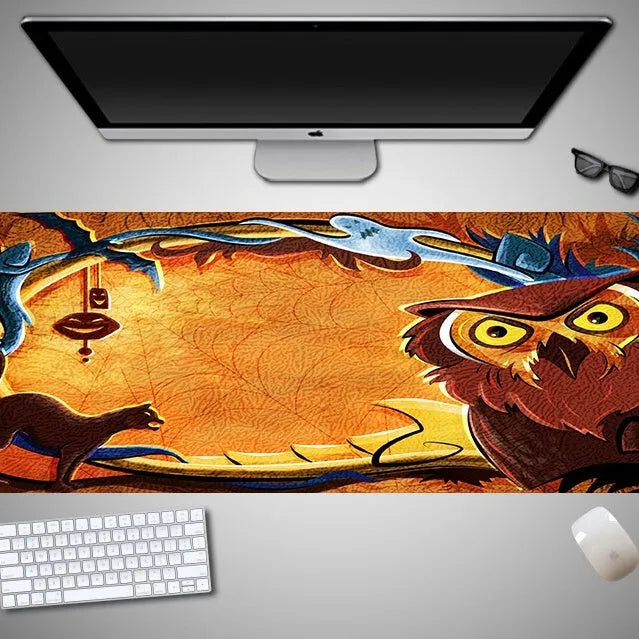 Oversized Halloween graphic cloth mouse pad on a desk, showing non-slip rubber base.