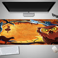 Oversized Halloween graphic cloth mouse pad on a desk, showing non-slip rubber base.