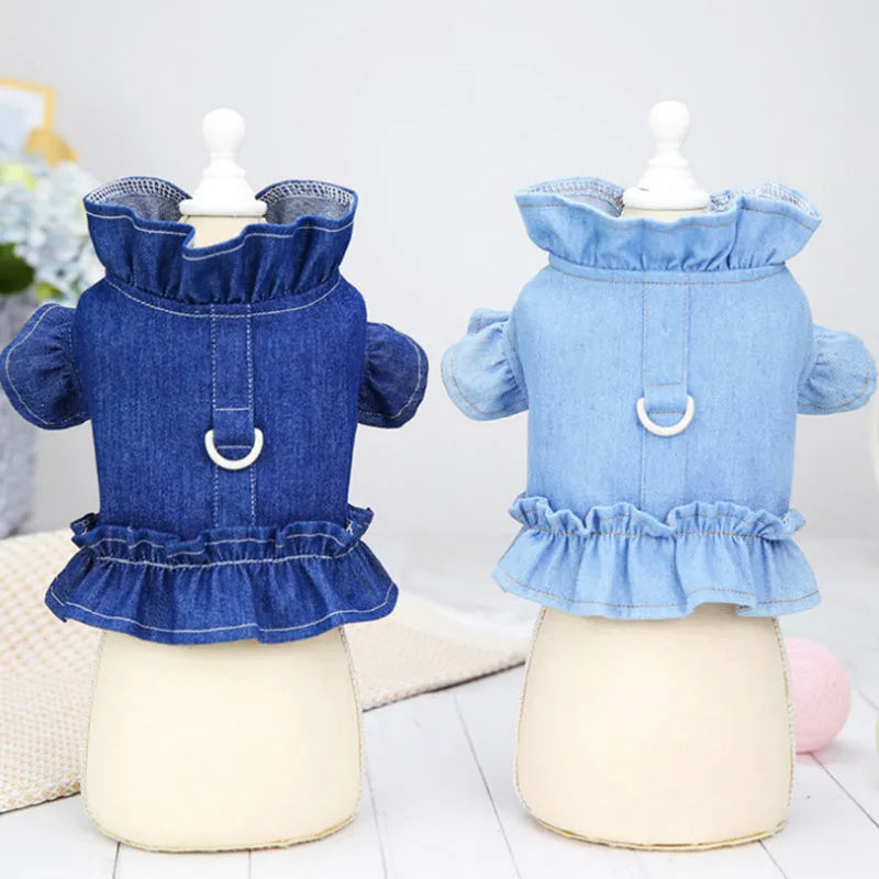 Blue denim dog dress with chest ruffles and a leash hook on the back, shown in dark blue and light blue.
