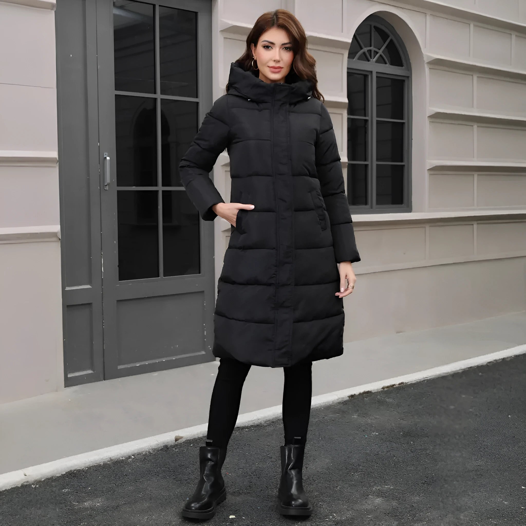 Black slim-fit hooded long cotton jacket for men on a hanger.