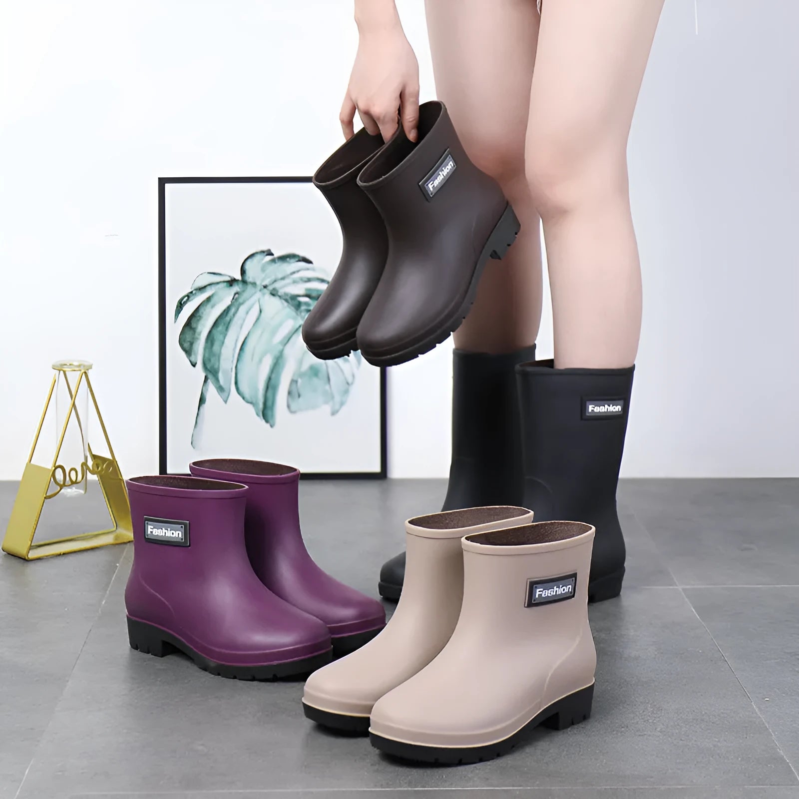 Women's mid-calf PVC rain boots in black with low heel design