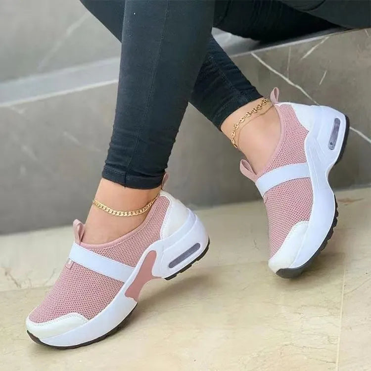 Women's white mesh flat sneakers with round toe and colour stitching on a rubber sole.