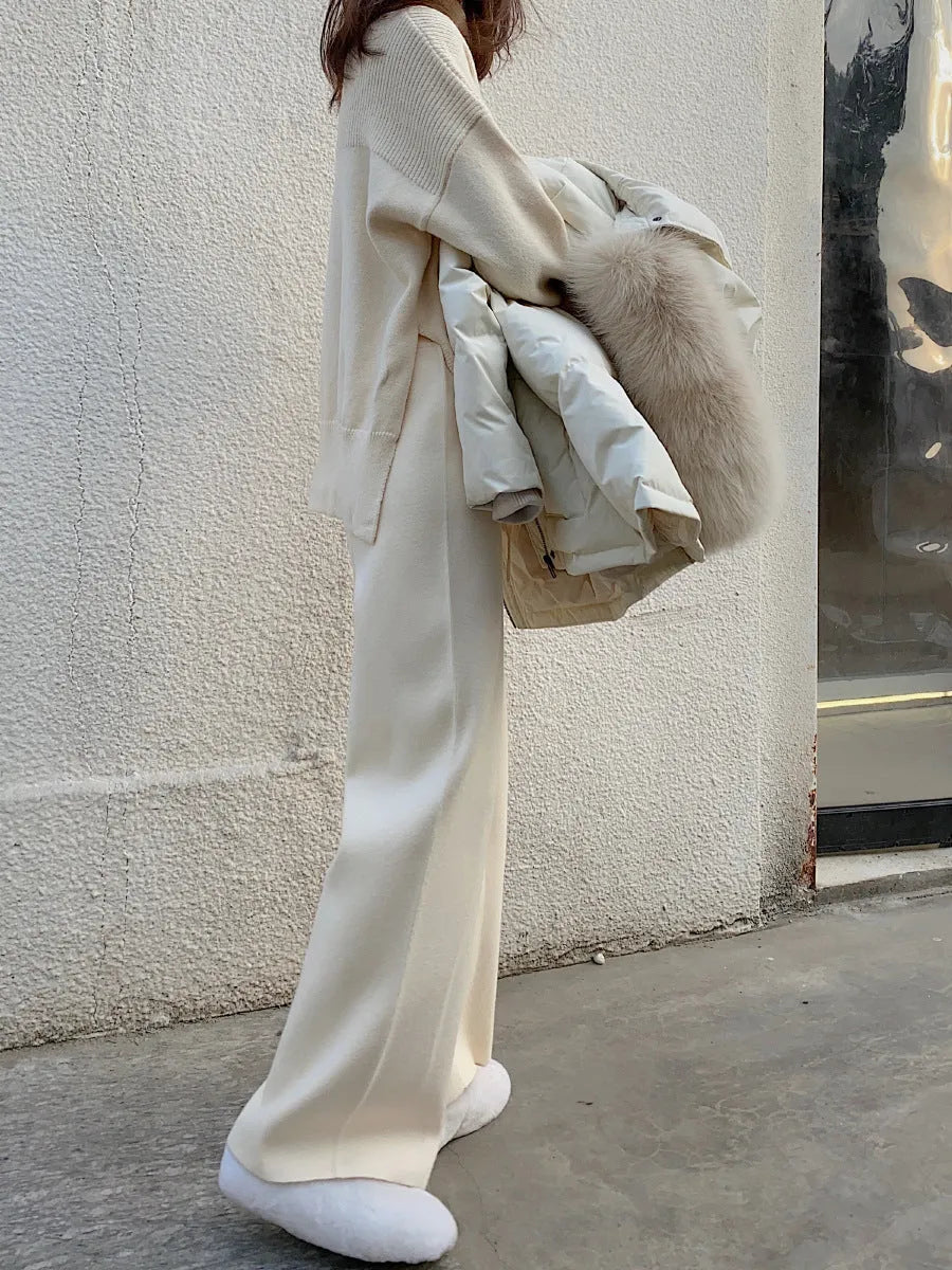 Women's high-waist knitted wide-leg trousers in a cream white colour, showcasing the straight-leg mopping style.
