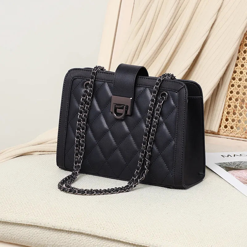 Women's black genuine leather chain crossbody square bag, soft underarm handbag on model