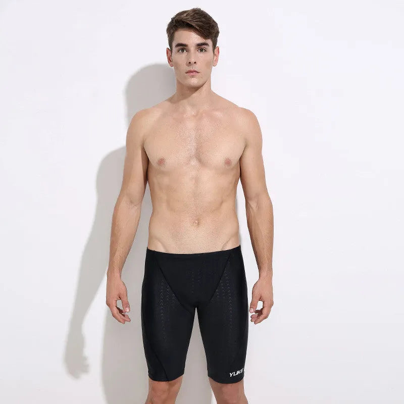 Men's black swim set with trunks, anti-fog goggles, waterproof cap, ear plugs with nose clip, and swimming bag