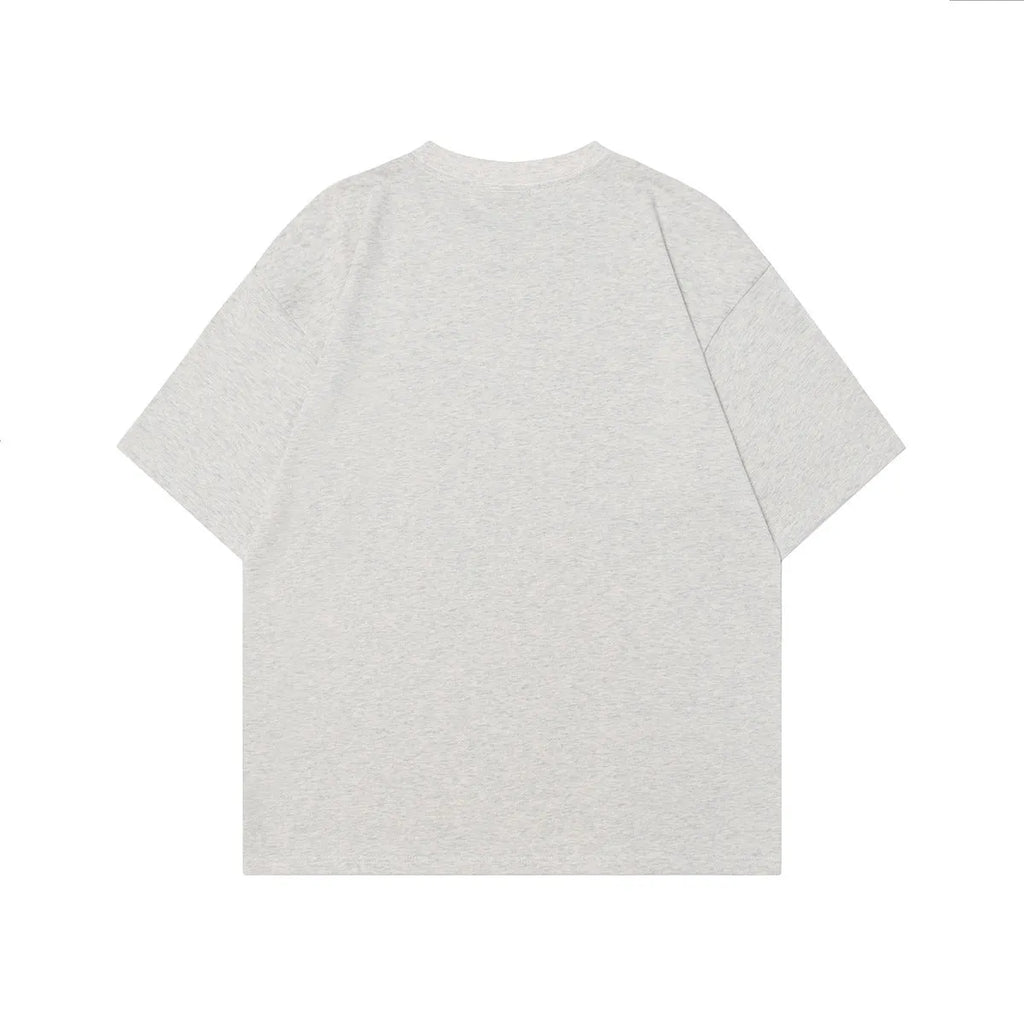 Men's grey loose-fit cotton T-shirt featuring a printed retro character design on the chest.