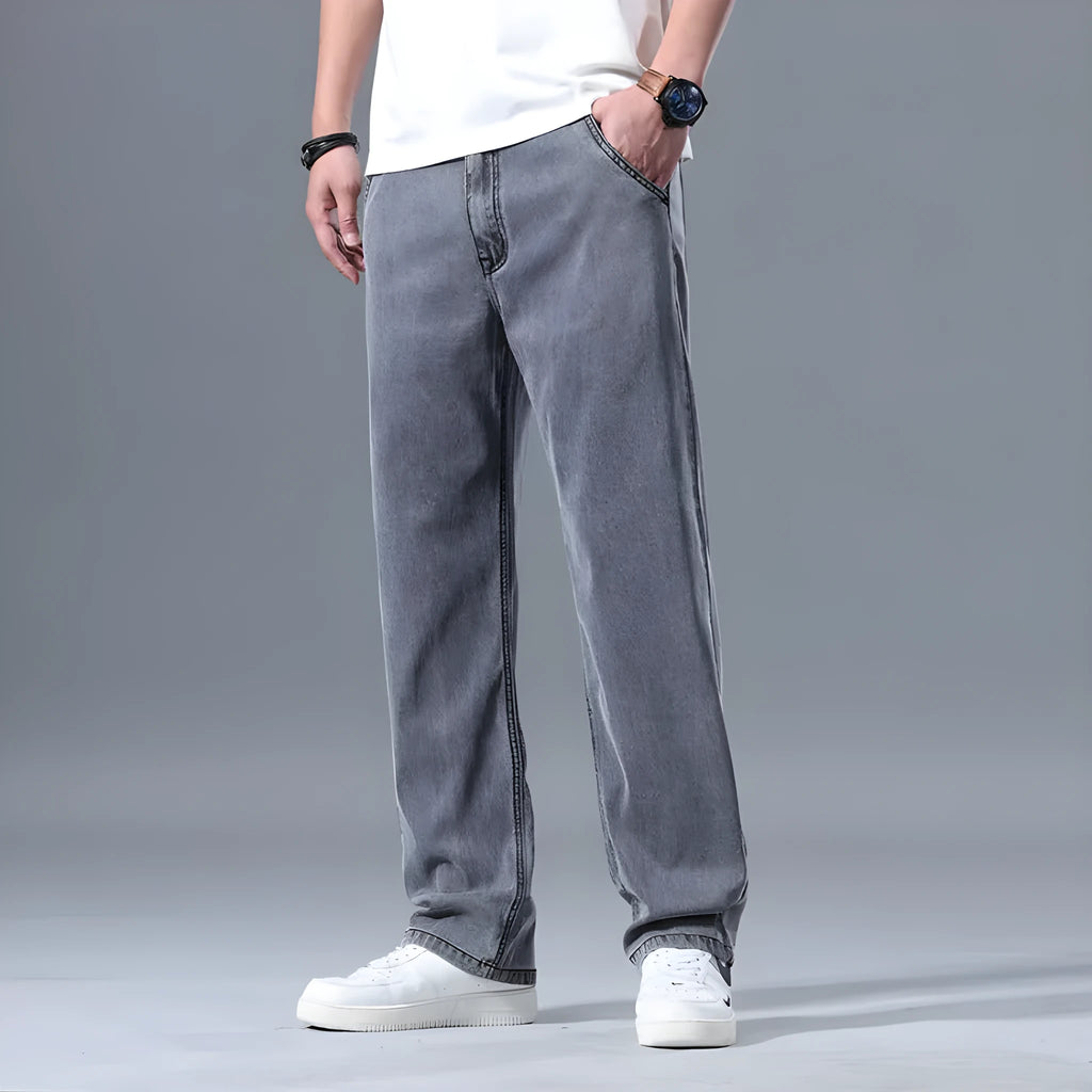 Men's light blue loose straight-leg lyocell jeans laid flat showing zip fly and relaxed fit