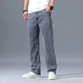 Men's light blue loose straight-leg lyocell jeans laid flat showing zip fly and relaxed fit