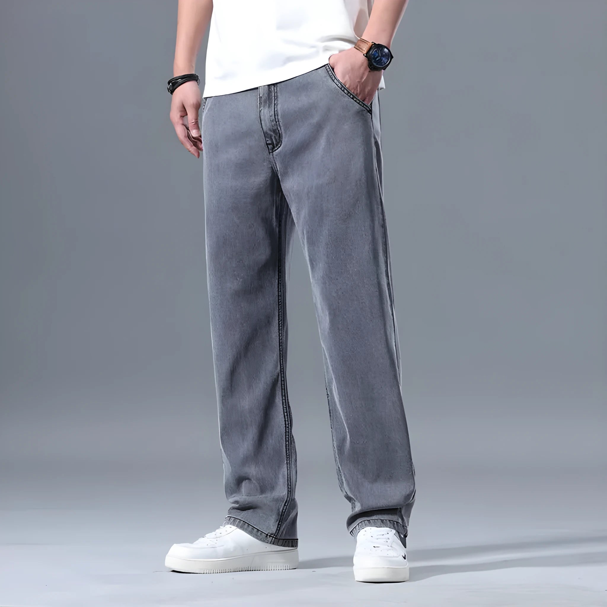 Men's light blue loose straight-leg lyocell jeans laid flat showing zip fly and relaxed fit