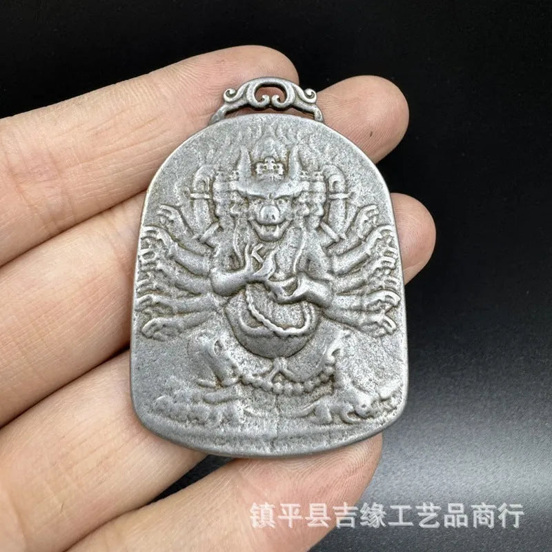 Close-up of a Chinese style iron wall pendant with geometric designs and Yamantaka figure.