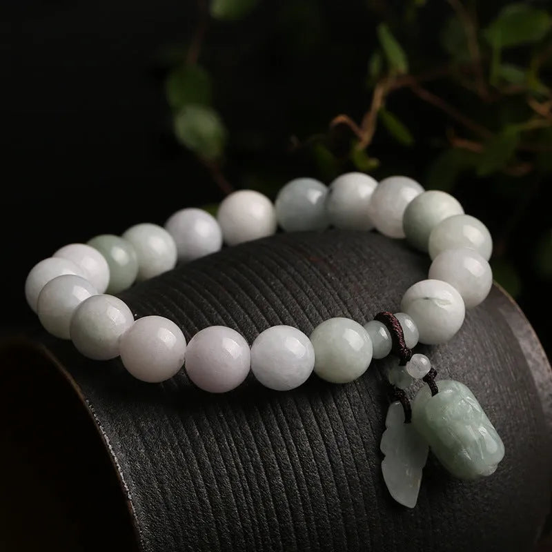 Natural green jade geometric bracelet with an adjustable chain and a hanging Maitreya Buddha charm.
