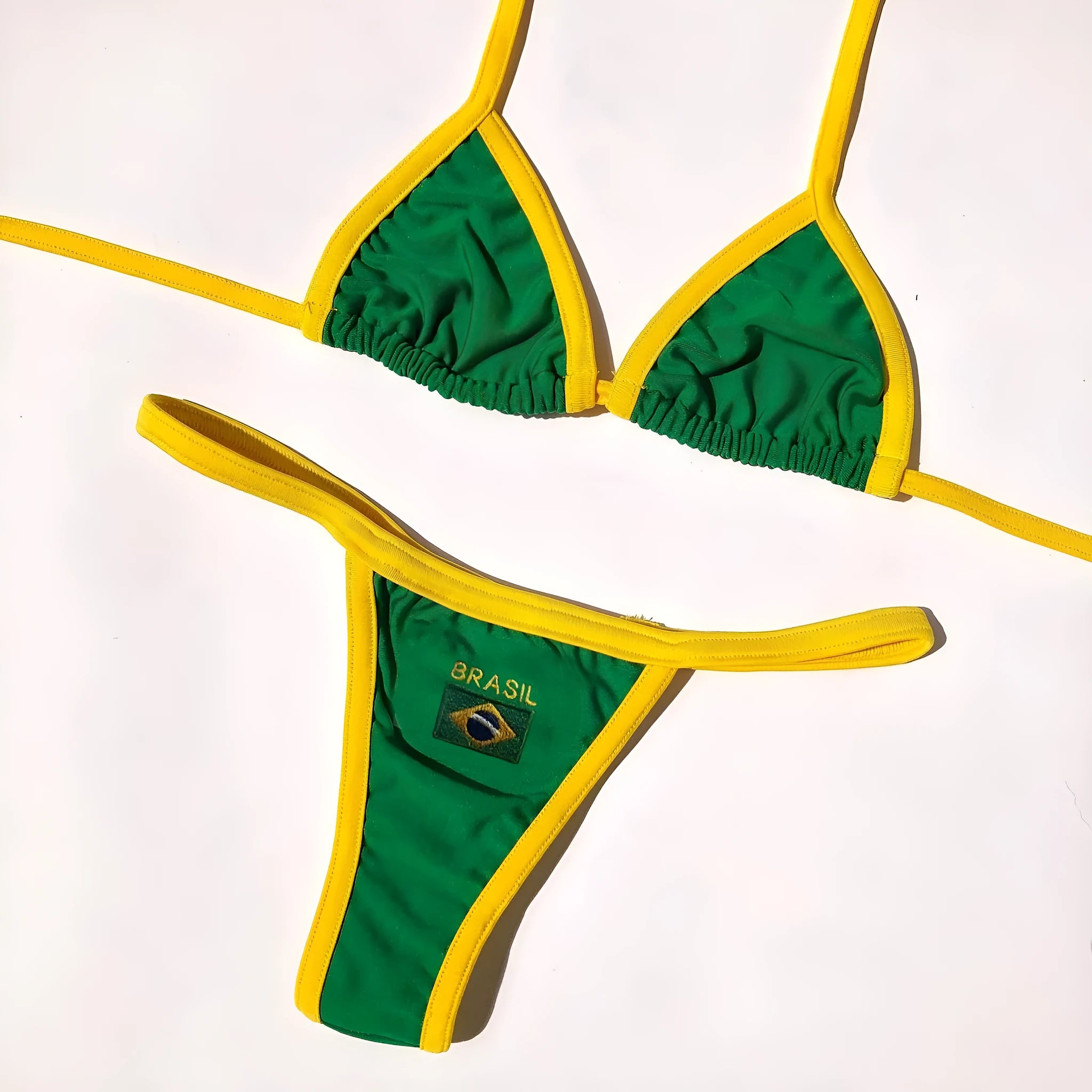Yellow women's T-back bikini top with matching shorts-length pants on a neutral background.