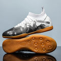 Low-top black and yellow football trainers with removable screw-in studs on the sole.