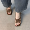 Women's light brown retro sandals with thin cross ankle straps and a square toe on a mid-height heel.