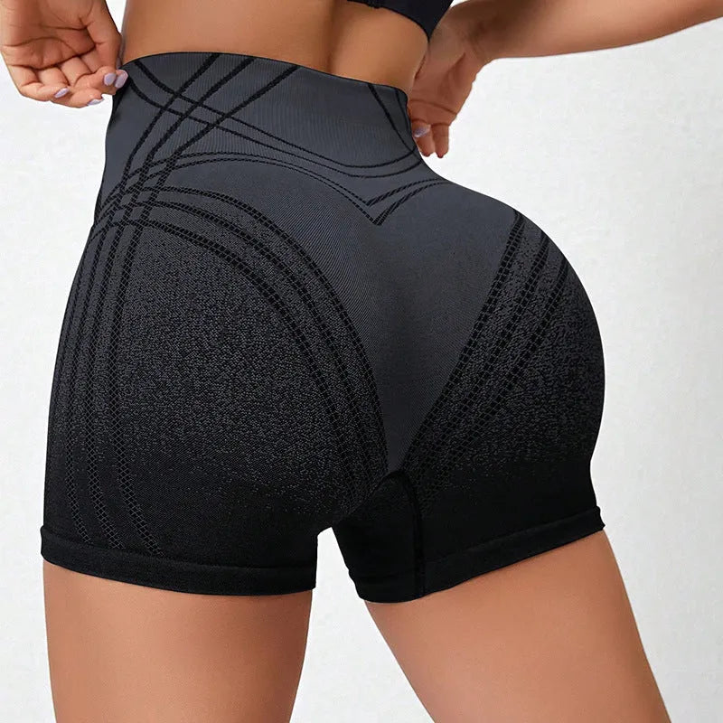 Women's high waisted gradient fitness shorts in black, shown with Spider-Man graphic.
