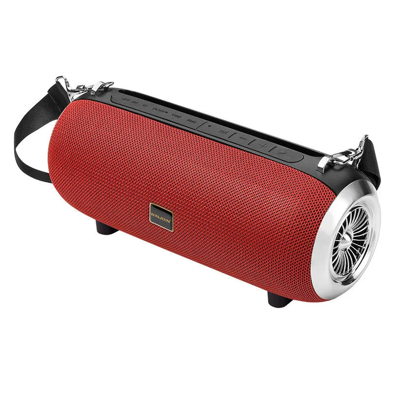 Square fabric portable Bluetooth speaker with FM antenna, shoulder strap, and phone stand groove.