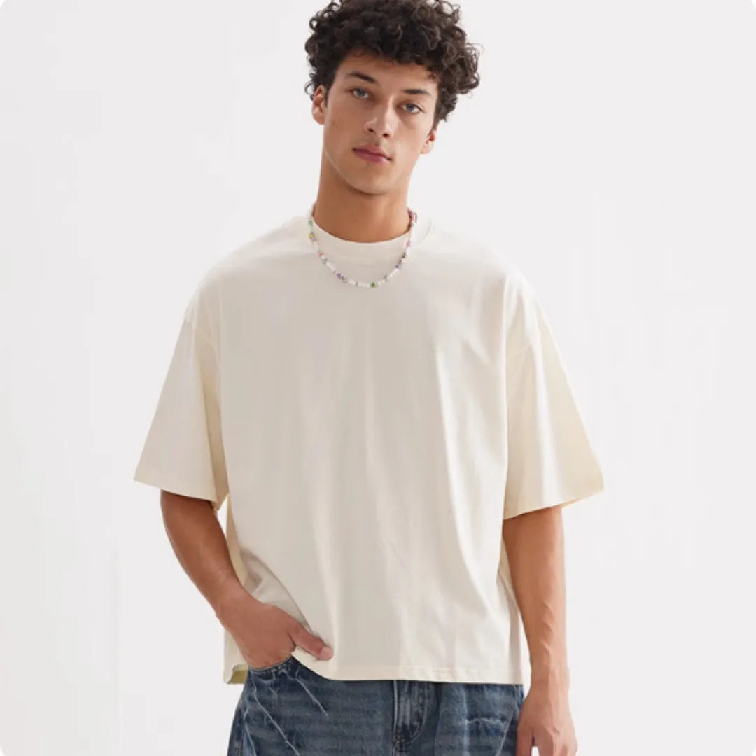 Pure cotton loose fit short sleeve t-shirt in apricot colour on a hanger.