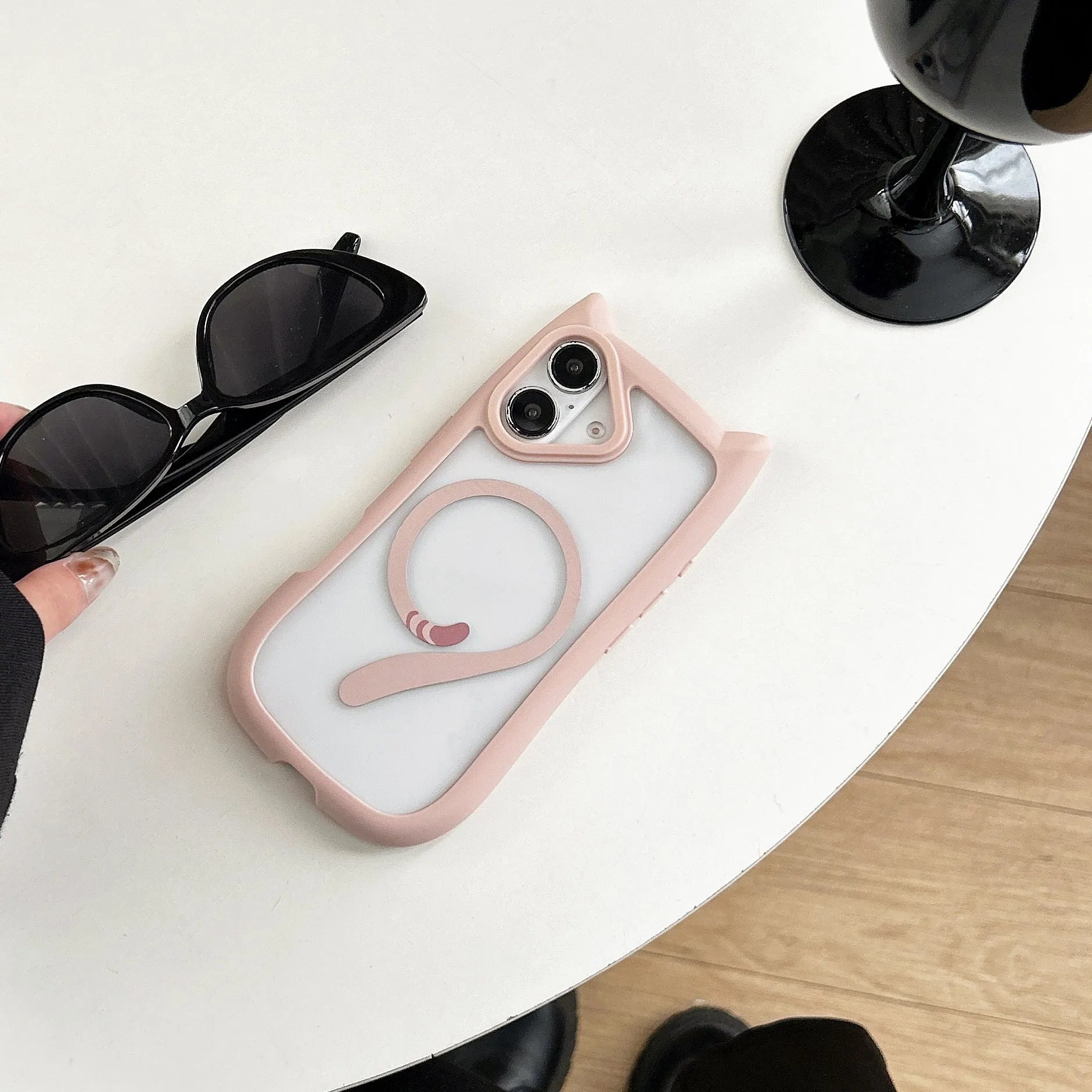 Transparent acrylic and TPU phone case for IPhone 17 with magnetic suction ring on back.