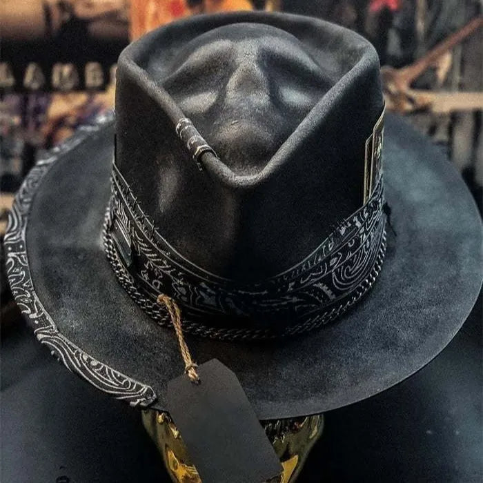 Handmade black skull hat with conical crown, made from wool and denim fabric, on a neutral background.