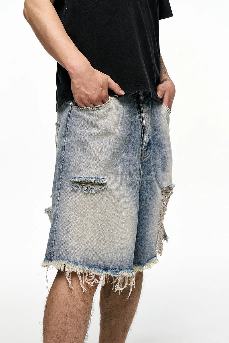 Men's light blue baggy denim shorts with wide leg and retro washed finish on a mid waist.