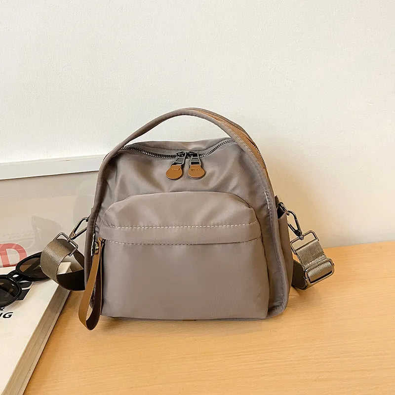 Vegan leather crossbody bag in black with double-stitched contrast thread, YKK zippers, and reinforced base