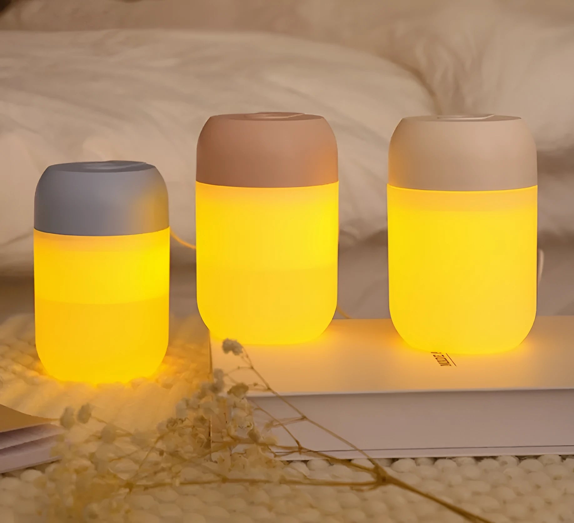 White cylindrical USB-powered mini humidifier with aromatherapy function on a desk.