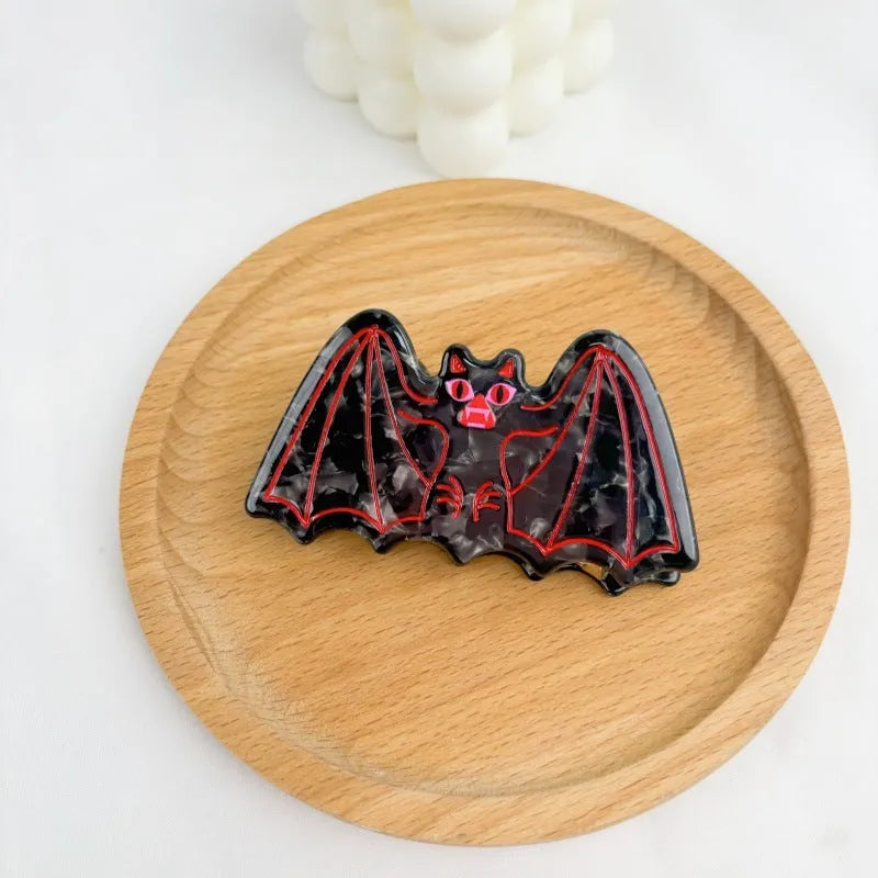 Halloween hair clip with detailed acetic acid shark and bat design in one of four colour variations.